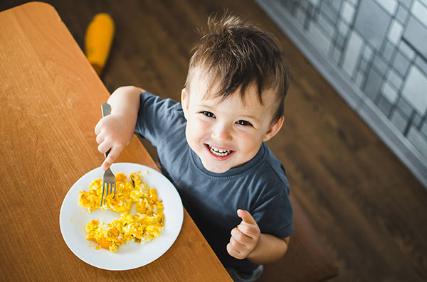 Boy eating eggs