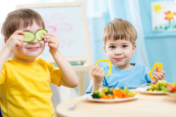 Boys eating vegetables