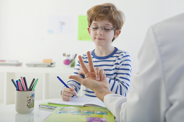 Boy writing in notebook